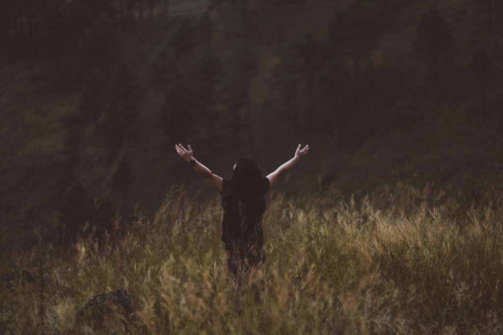 Person with outstretched arms happy they found a Christian 12 step program