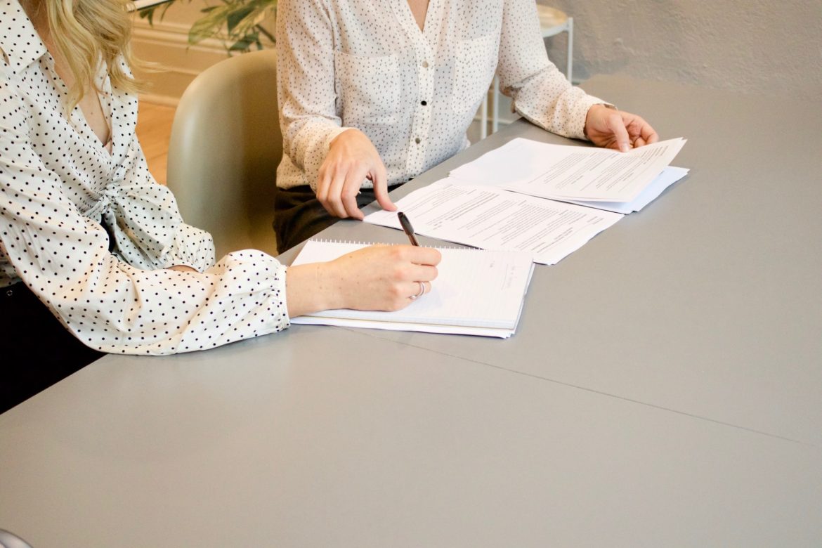 two persons checking some documents on the table in drug rehab centers in WV that accept Medicaid