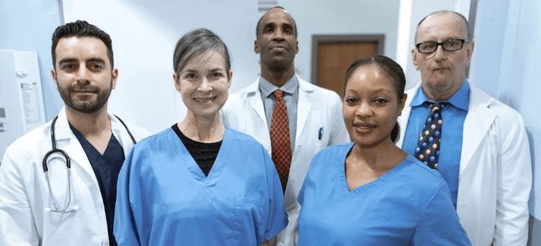 Healthcare professionals smiling at the camera.