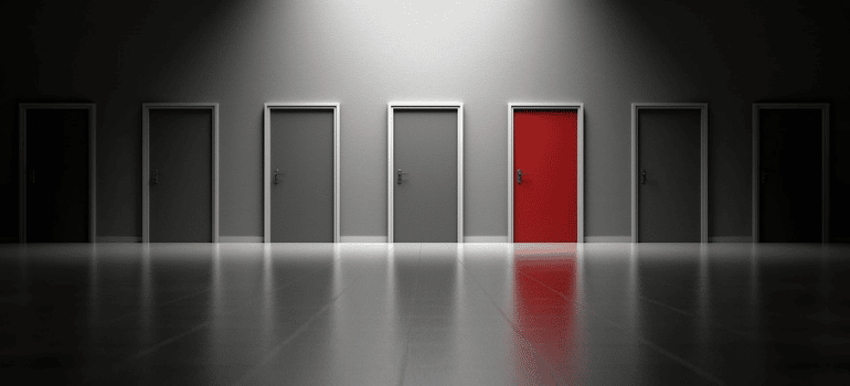 An illustration of a red door around grey ones.