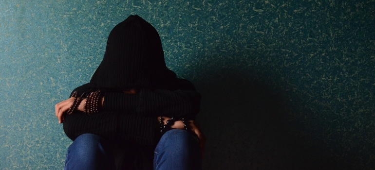 young adult person in a black hoodie
