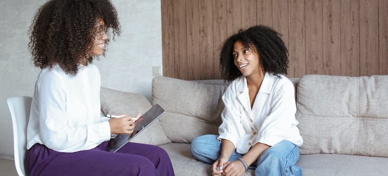 Young black woman talking to a black therapist.