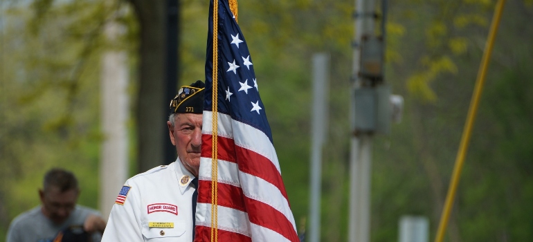 a U.S. veteran, holding a flag