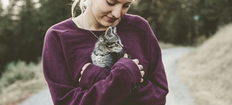 Woman holding a kitten.