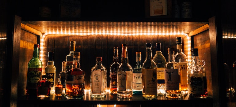 Alcohol bottles on a bar.