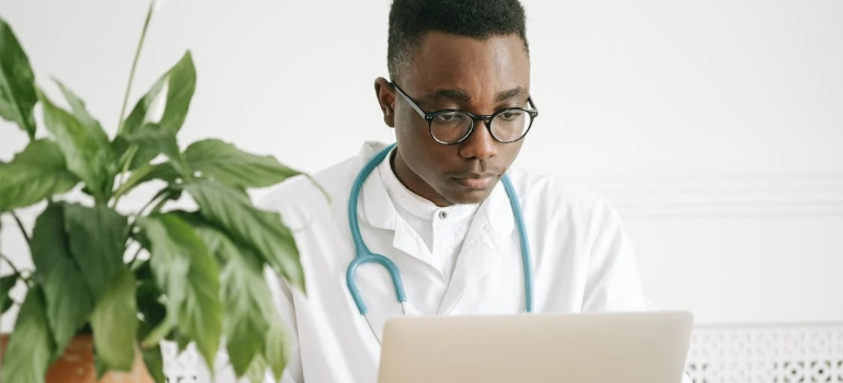 A doctor looking at a laptop screen to help you prepare for a cocaine detox program in West Virginia.