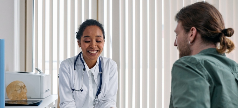 smiling doctor talking to a patient