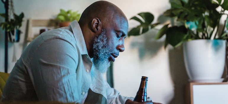 Man drinking a beer and proving myths of alcohol relapse true.