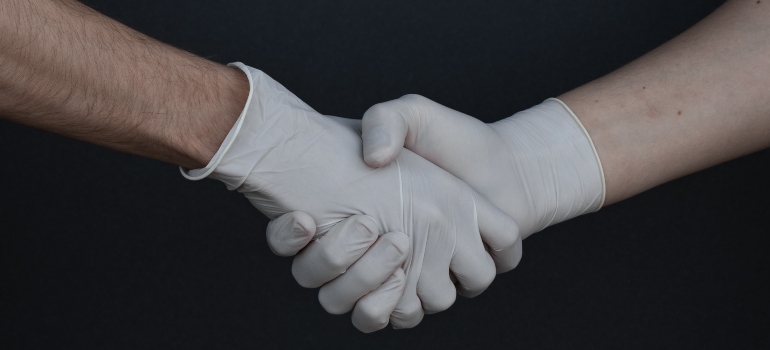 a handshake in white gloves