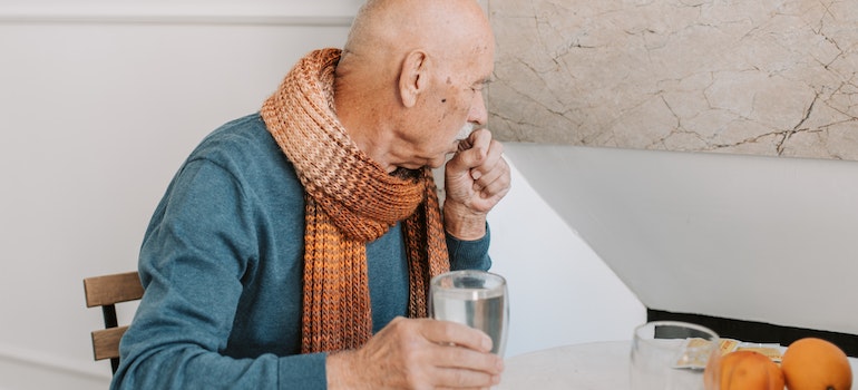 An elderly person coughing