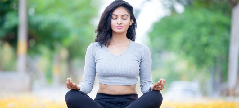 calm woman meditating as a way to overcome the most common obstacles to making positive changes in life