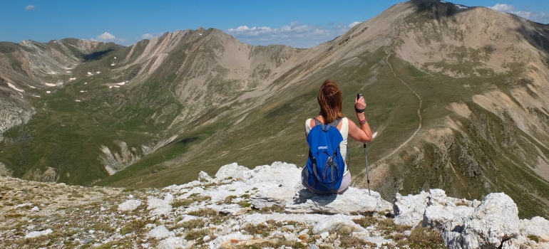 woman hiking in the mountains representing one of the activities for moms in recovery