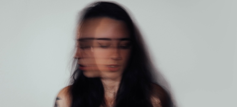 a blurry face of a woman representing how toxic relationships influence addiction