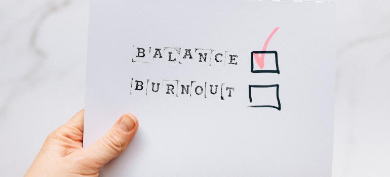 balance and burnout typed on a piece of paper and a checked box next to the word balance