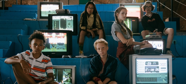 pre-teens posing next to television screens representing how media and television influence drug use