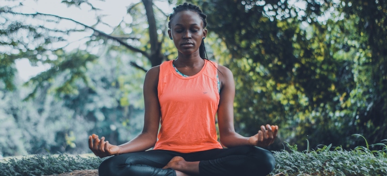 focused black woman meditating