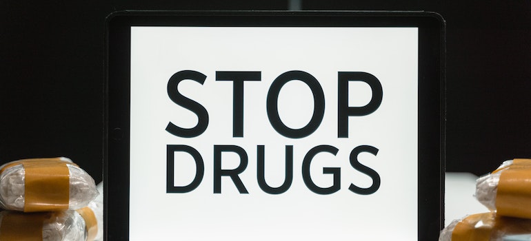Screen with stop drugs written on it representing the difference between physical and psychological addiction