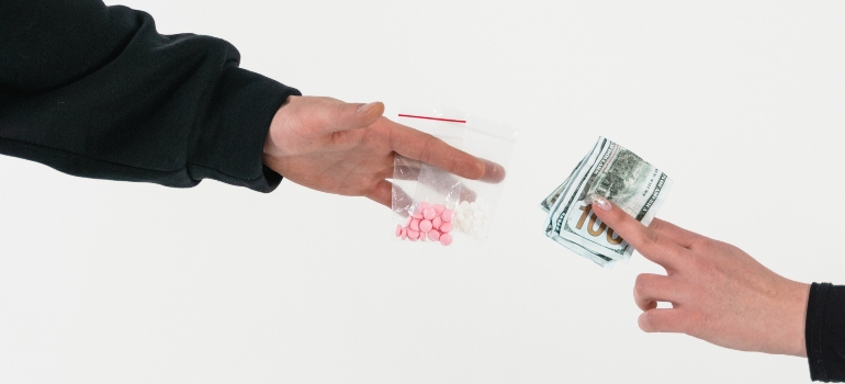 person paying for a satchet of drugs