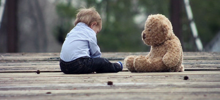 A child playing with a teddy bear