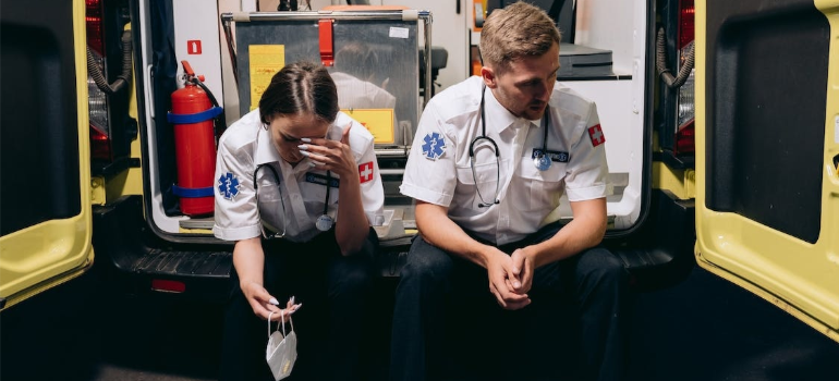 Two paramedics on an ambulance, illustrating how the involvement of pharmaceutical companies in the opioid epidemic cost lives.