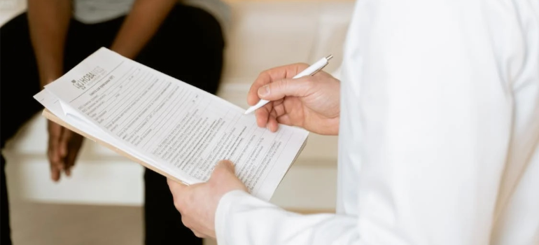 A close-up of a medical professional examining a paper, illustrating the role of healthcare professionals in combating benzodiazepine addiction in WV.
