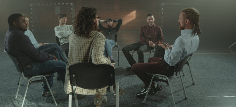 A group of people during a psychotherapy session indoors.