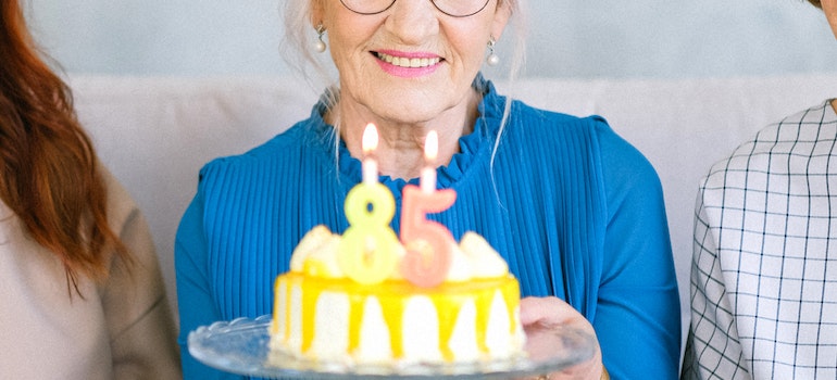 an older woman celebrating her 85 birthday overcoming the impact of alcohol addiction on older adults