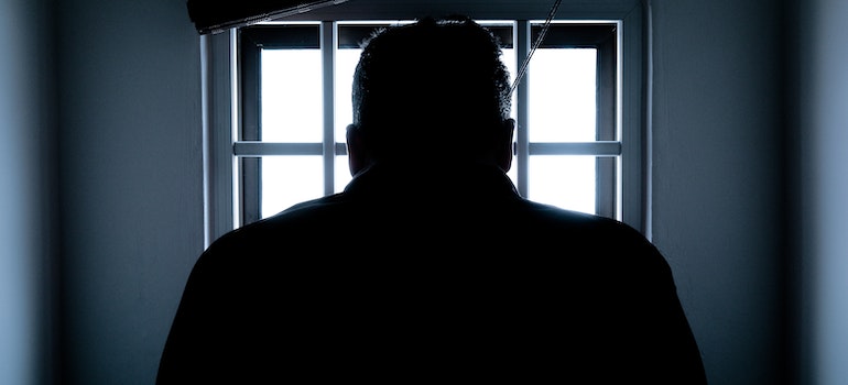 a person looking through the bars affected by the impact of addiction on the local prison population in Clarksburg, WV