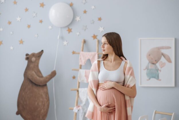 A pregnant woman in a child's room