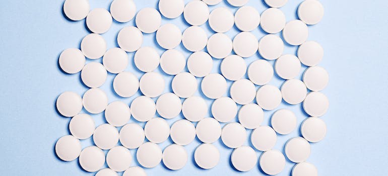 Pills of nitazenes on a blue background, representing Nitazenes Abuse in WV