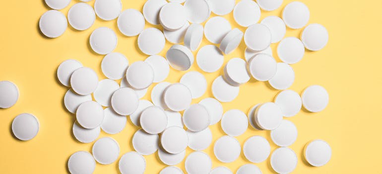 White pills on a yellow background