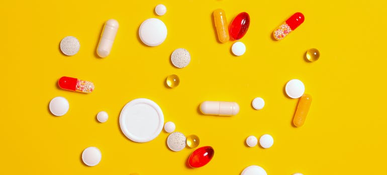 Different types of pills on a yellow background