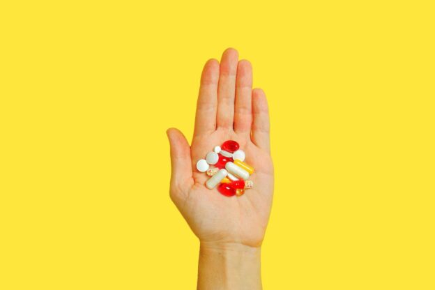 A hand holding pills
