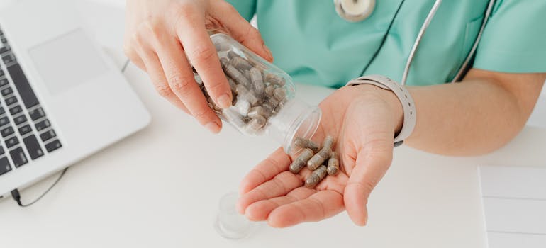 A doctor holding pills