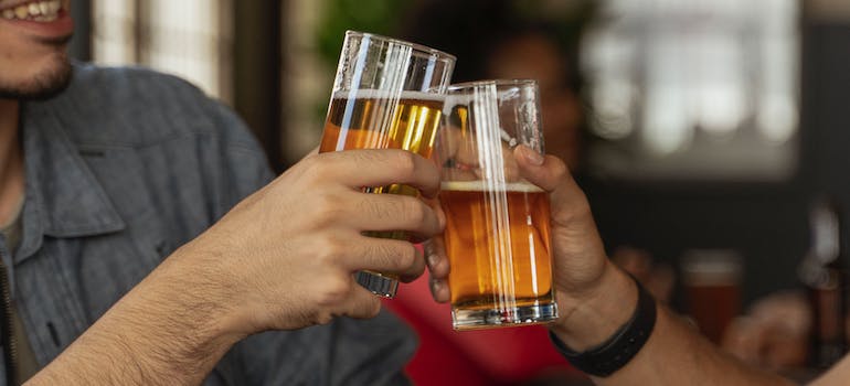 People drinking beer together as a sign of bonding, which is one of the cultural factors in addiction in West Virginia