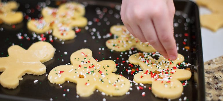 person baking gingerbread cookies representing why Holidays Are Difficult for People With Addictions