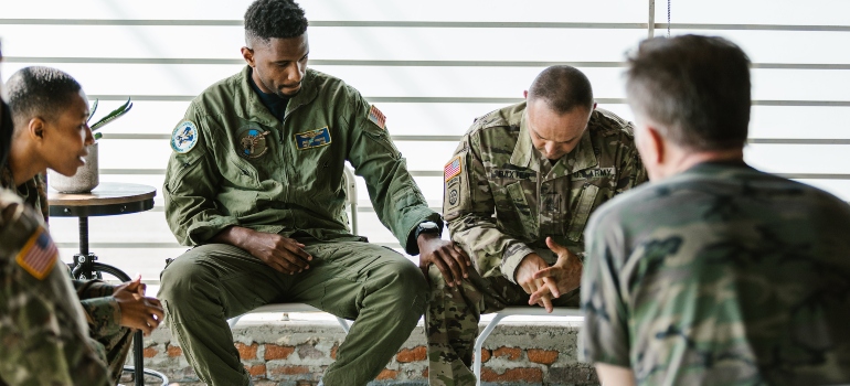 Men in military uniform in group therapy