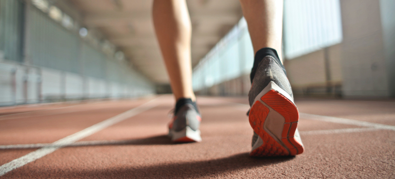 A close-up of a runner's feet, highlighting the value of exercise and endurance.