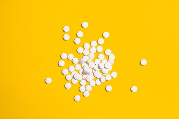White pills on the yellow background