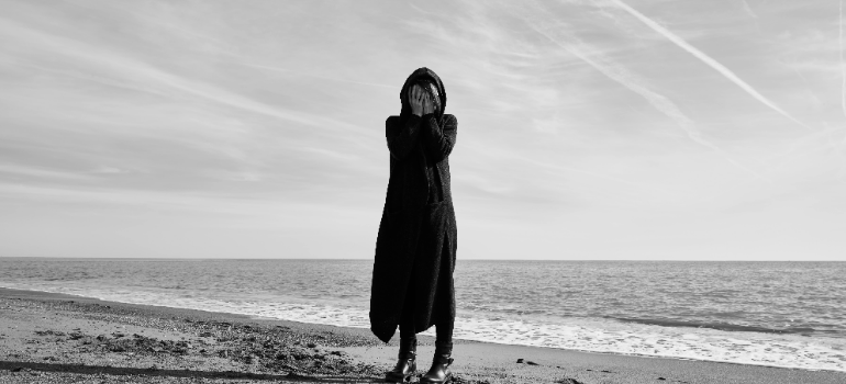 a woman standing on a beach