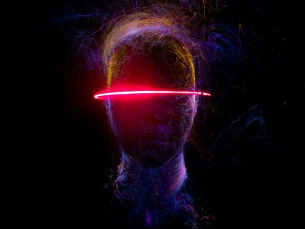 An illustration of a human head with a laser light around it