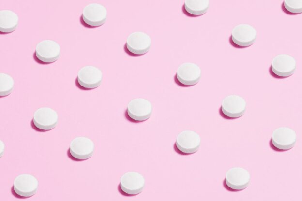 White pills on a purple background