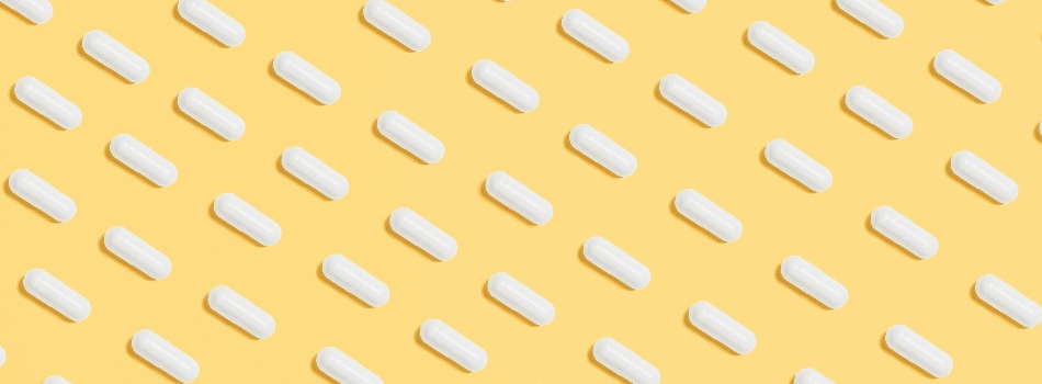 White pills on a yellow background