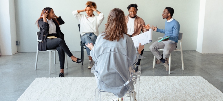 A group of people talking to a therapist
