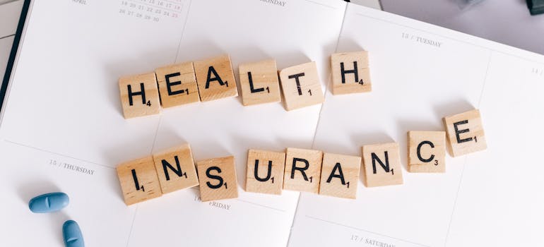 health insurance scrabble tiles on a planner.