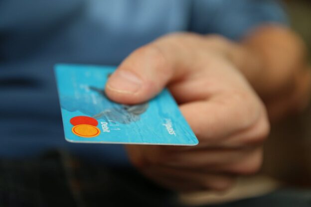 man paying the outpatient rehab cost in WV with a debit card.