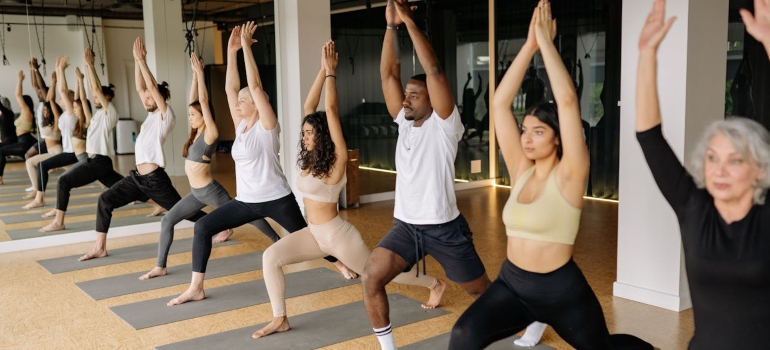 People doing pose in yoga class