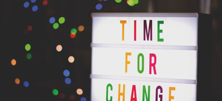A time for change multi colored sign on a black background