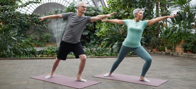 Elderly couple practicing yoga