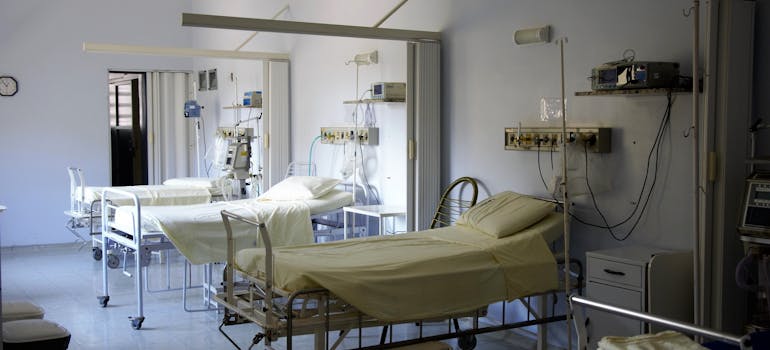 Hospital room with three beds.